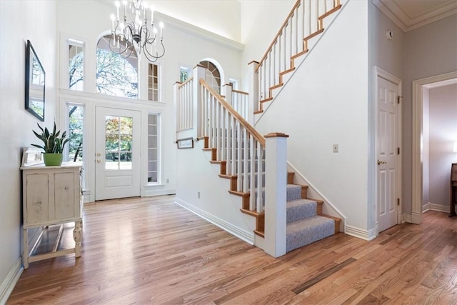 1325 Avery Pl, Siloam Springs, AR 72761 - foyer with a towering ceiling, stairs, wood finished floors, a chandelier, and baseboards