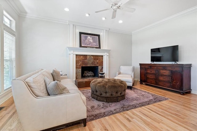 1325 Avery Pl, Siloam Springs, AR 72761 - living area with a ceiling fan, crown molding, wood finished floors, recessed lighting, and a stone fireplace