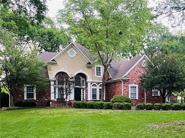 1325 Avery Pl, Siloam Springs, AR 72761 - view of front of home with a front lawn, brick siding, and stucco siding