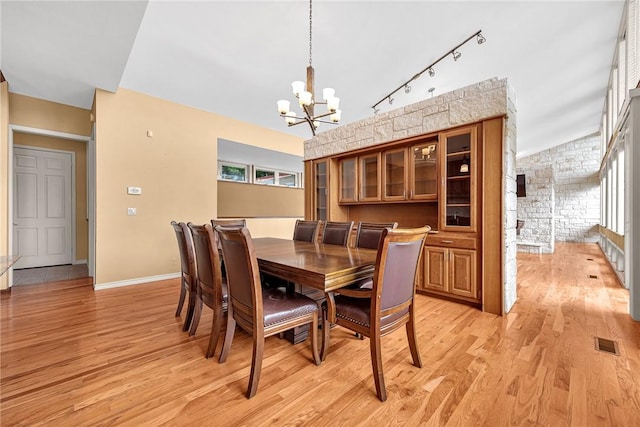 289 County Road 1521, Eureka Springs, AR 72632 - dining space featuring a chandelier, light wood finished floors, rail lighting, and baseboards