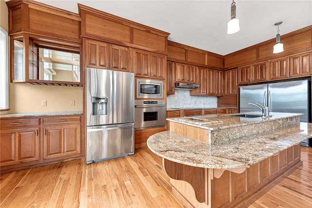 289 County Road 1521, Eureka Springs, AR 72632 - kitchen featuring appliances with stainless steel finishes, under cabinet range hood, a sink, and brown cabinets