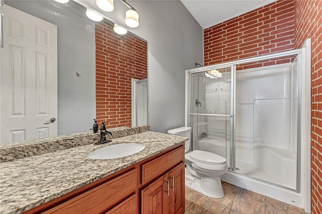 289 County Road 1521, Eureka Springs, AR 72632 - full bathroom with brick wall, a stall shower, vanity, toilet, and stone finish flooring