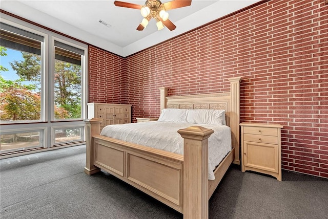 289 County Road 1521, Eureka Springs, AR 72632 - bedroom with dark carpet, brick wall, and a ceiling fan