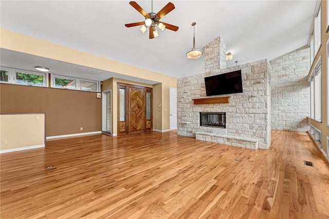289 County Road 1521, Eureka Springs, AR 72632 - unfurnished living room with light wood finished floors, ceiling fan, a fireplace, and baseboards