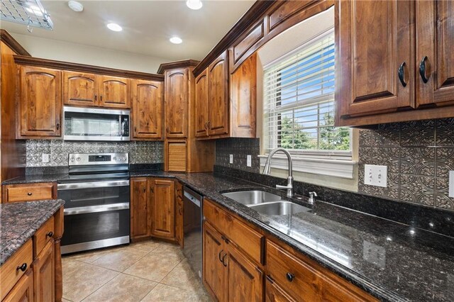 8 Allonby Cir, Bella Vista, AR 72714 - kitchen with appliances with stainless steel finishes, a sink, light tile patterned floors, backsplash, and dark stone counters