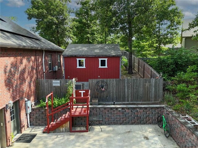 8 Allonby Cir, Bella Vista, AR 72714 - fenced backyard featuring a patio area, an outbuilding, and stairs