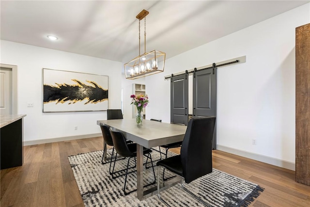 839 Saffron Ave, Tontitown, AR 72762 - dining area featuring a barn door, wood finished floors, baseboards, and recessed lighting