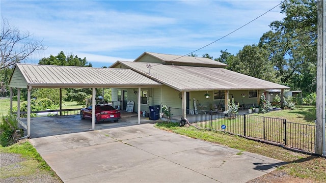 12088 State Highway 28, Dardanelle, AR 72834 - view of front facade featuring driveway, a carport, and metal roof