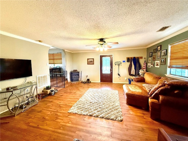 12088 State Highway 28, Dardanelle, AR 72834 - living area with ornamental molding, a textured ceiling, wood finished floors, ceiling fan, and arched walkways