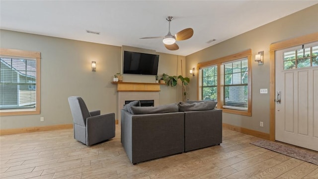 1806 Best Friend Ln, Fayetteville, AR 72704 - living room with a fireplace, light wood-type flooring, a ceiling fan, and baseboards