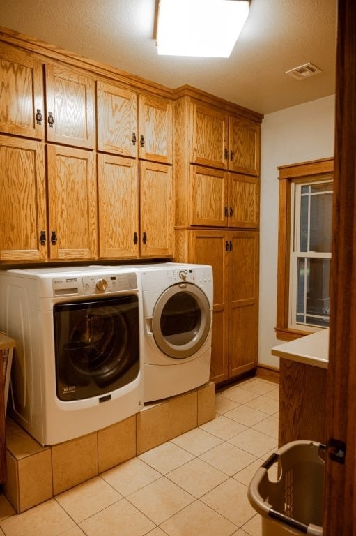 8295 Ridgecrest Ln, Rogers, AR 72756 - laundry room with cabinet space, washer and clothes dryer, and light tile patterned floors