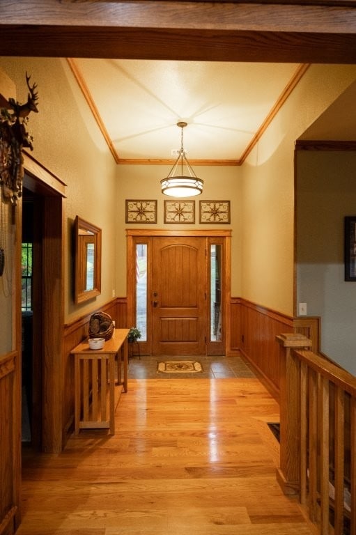 8295 Ridgecrest Ln, Rogers, AR 72756 - entrance foyer with wainscoting, healthy amount of natural light, ornamental molding, light wood finished floors, and wooden walls