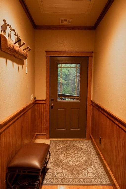 8295 Ridgecrest Ln, Rogers, AR 72756 - entryway featuring wainscoting, ornamental molding, and wooden walls