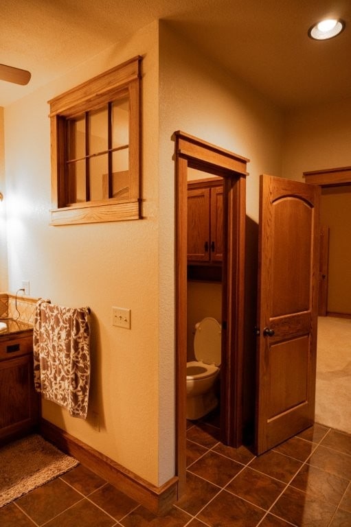 8295 Ridgecrest Ln, Rogers, AR 72756 - bathroom with vanity, toilet, tile patterned floors, and recessed lighting