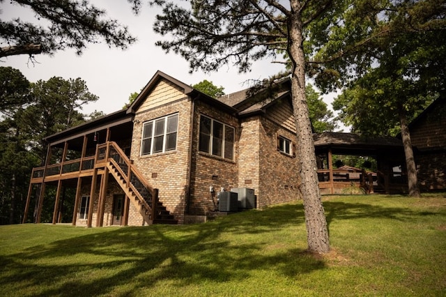 8295 Ridgecrest Ln, Rogers, AR 72756 - back of property with stairs, a lawn, brick siding, and central air condition unit