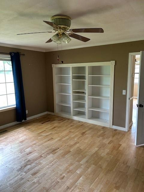 1103 NW 10th St, Bentonville, AR 72712 - empty room with crown molding, baseboards, light wood-type flooring, and ceiling fan