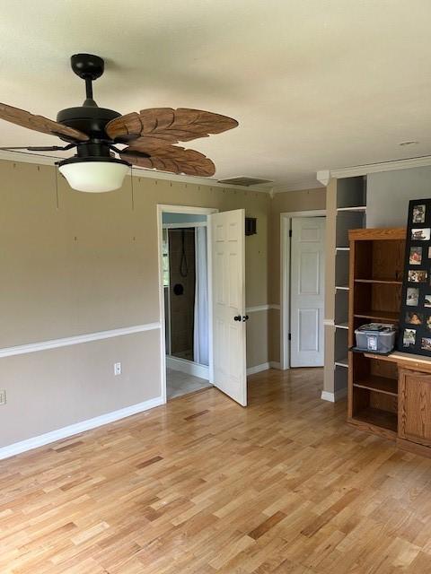 1103 NW 10th St, Bentonville, AR 72712 - unfurnished room featuring a ceiling fan, light wood-style floors, crown molding, and baseboards