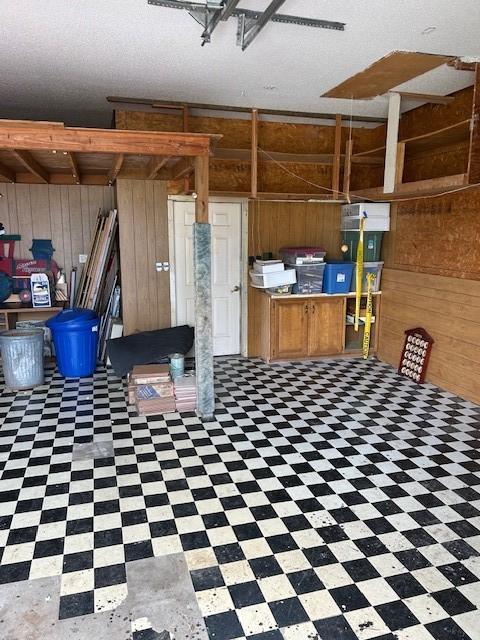 1103 NW 10th St, Bentonville, AR 72712 - miscellaneous room with wooden walls and tile patterned floors