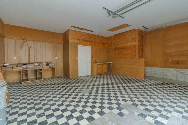 1103 NW 10th St, Bentonville, AR 72712 - kitchen with tile patterned floors and wood walls