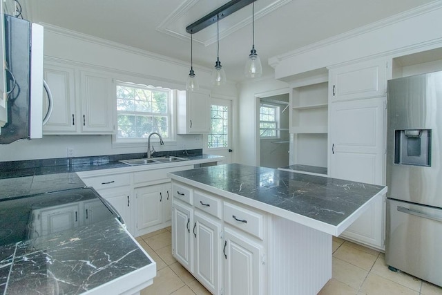 1103 NW 10th St, Bentonville, AR 72712 - kitchen featuring stainless steel refrigerator with ice dispenser, light tile patterned floors, white cabinetry, ornamental molding, and decorative light fixtures