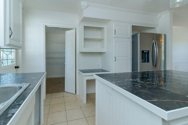 1103 NW 10th St, Bentonville, AR 72712 - kitchen with stainless steel refrigerator with ice dispenser, crown molding, white cabinets, light tile patterned floors, and open shelves