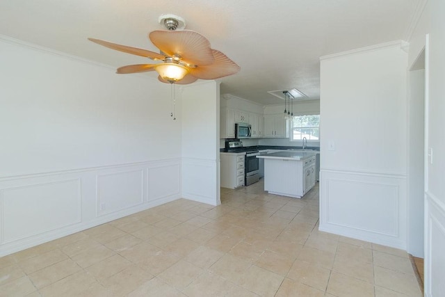 1103 NW 10th St, Bentonville, AR 72712 - kitchen with appliances with stainless steel finishes, a decorative wall, crown molding, a ceiling fan, and a wainscoted wall