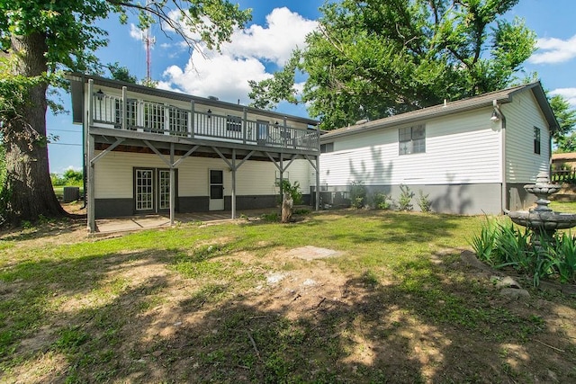1103 NW 10th St, Bentonville, AR 72712 - back of property featuring french doors, a lawn, a patio area, and a wooden deck