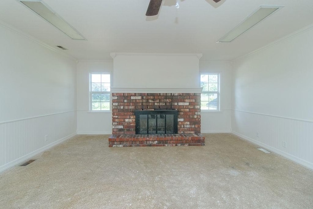 1103 NW 10th St, Bentonville, AR 72712 - unfurnished living room featuring ornamental molding, carpet, wainscoting, a fireplace, and a ceiling fan