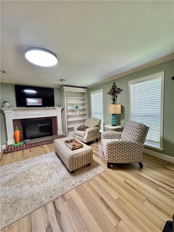 904 Deerfield Ct, Russellville, AR 72801 - living room with ornamental molding, a fireplace, wood finished floors, and baseboards