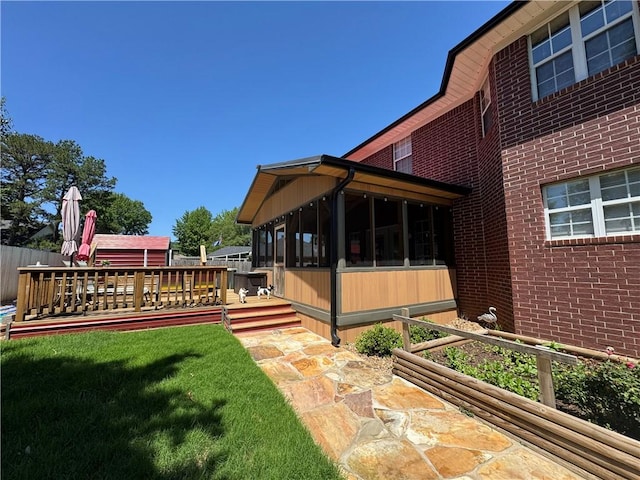 904 Deerfield Ct, Russellville, AR 72801 - view of green lawn with a sunroom and a deck