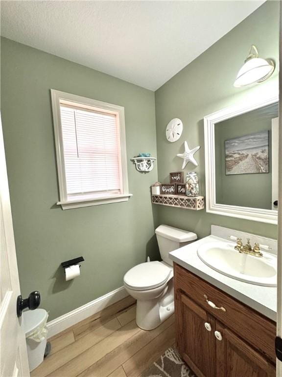 904 Deerfield Ct, Russellville, AR 72801 - half bath with wood finished floors, vanity, toilet, and baseboards