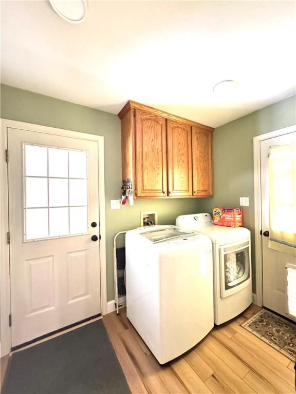 904 Deerfield Ct, Russellville, AR 72801 - washroom with cabinet space, washing machine and dryer, and light wood-style flooring