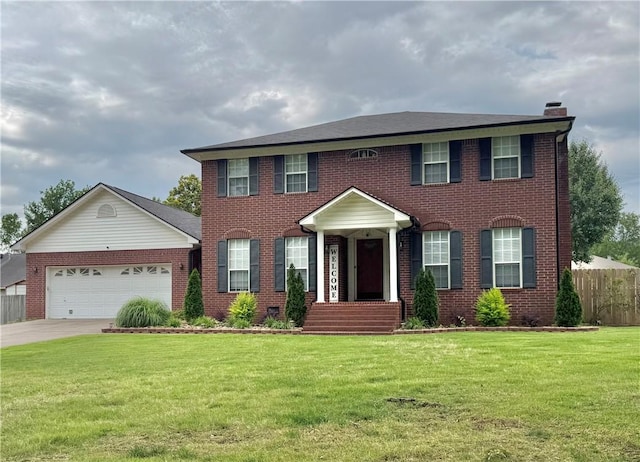 904 Deerfield Ct, Russellville, AR 72801 - colonial inspired home with brick siding, an attached garage, driveway, and a chimney