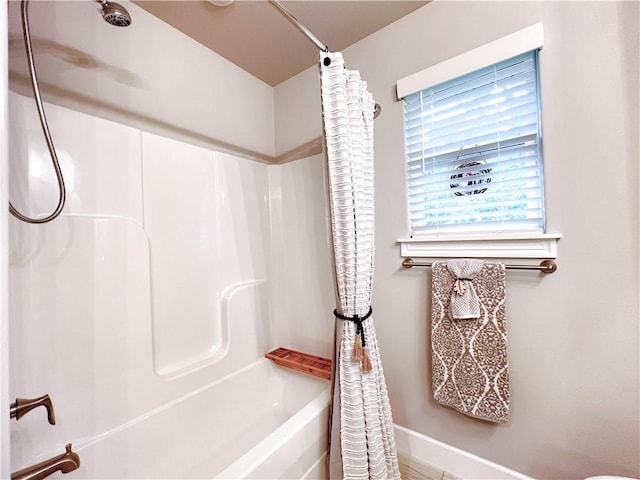 219 Kinross Dr, Bella Vista, AR 72715 - bathroom with shower / tub combo and baseboards