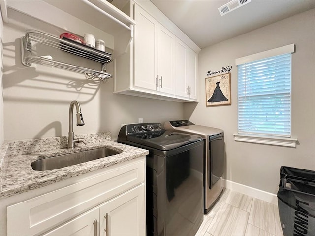 219 Kinross Dr, Bella Vista, AR 72715 - laundry room with washing machine and clothes dryer, cabinet space, and baseboards