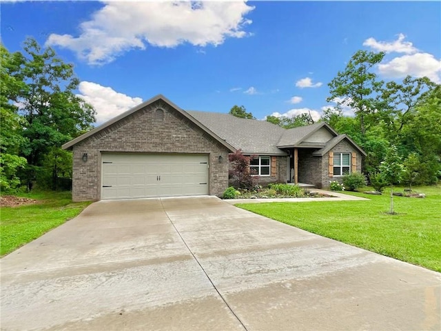 219 Kinross Dr, Bella Vista, AR 72715 - ranch-style house with an attached garage, concrete driveway, a front lawn, and brick siding