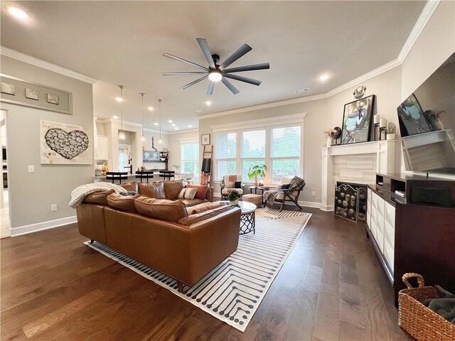 219 Kinross Dr, Bella Vista, AR 72715 - living area with ceiling fan, ornamental molding, baseboards, dark wood-style flooring, and a fireplace
