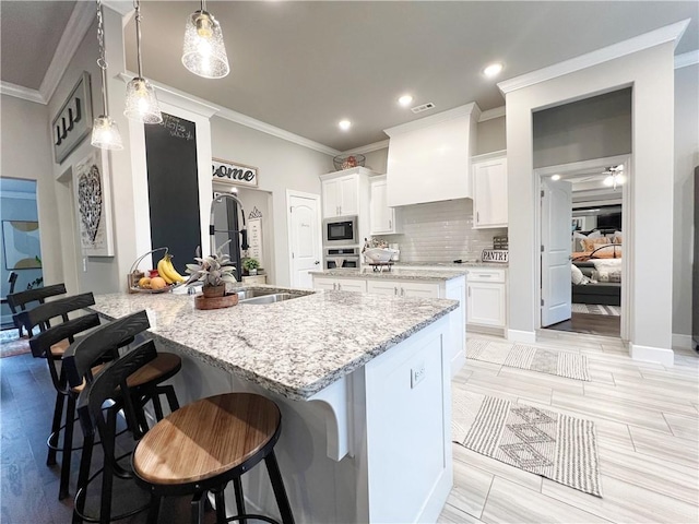 219 Kinross Dr, Bella Vista, AR 72715 - kitchen with built in microwave, oven, a peninsula, a kitchen breakfast bar, and white cabinetry