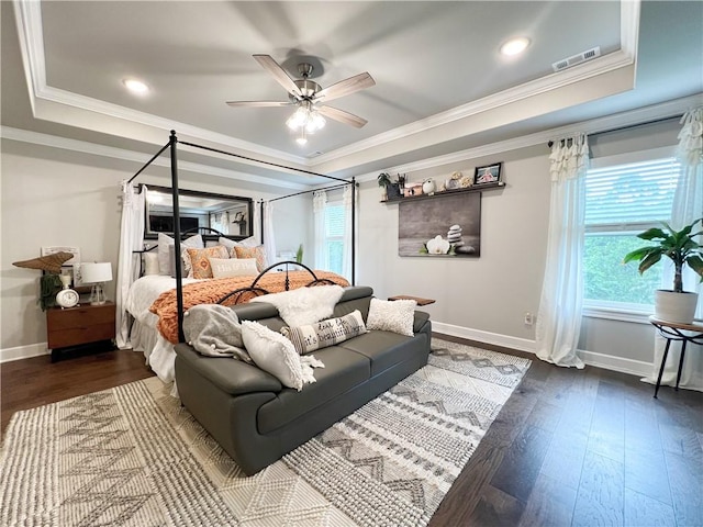 219 Kinross Dr, Bella Vista, AR 72715 - bedroom with baseboards, multiple windows, a raised ceiling, crown molding, and dark wood-style floors
