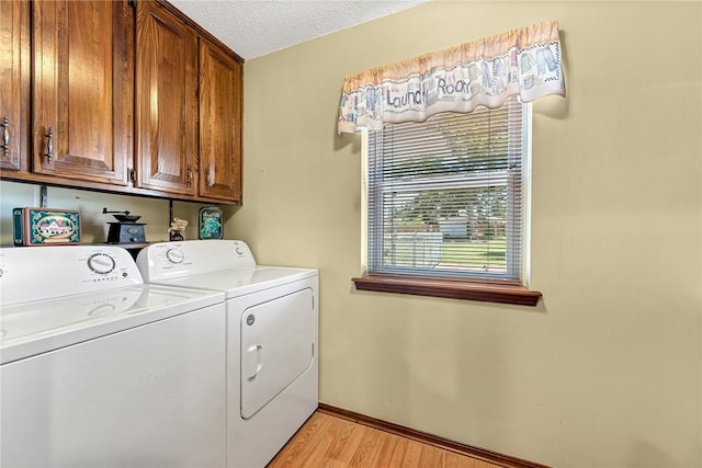 2001 W Magnolia St, Rogers, AR 72758 - laundry room featuring separate washer and dryer, cabinet space, light wood-style floors, a textured ceiling, and baseboards
