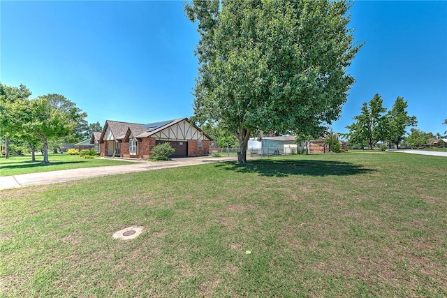2001 W Magnolia St, Rogers, AR 72758 - view of front of house with solar panels, concrete driveway, an attached garage, and brick siding
