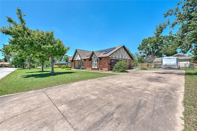 2001 W Magnolia St, Rogers, AR 72758 - view of side of property with concrete driveway, roof mounted solar panels, and brick siding