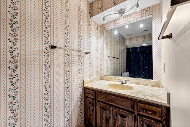 2001 W Magnolia St, Rogers, AR 72758 - bathroom featuring vanity and wallpapered walls