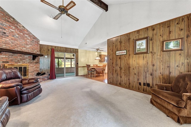 2001 W Magnolia St, Rogers, AR 72758 - living area featuring a ceiling fan, wooden walls, high vaulted ceiling, carpet floors, and beamed ceiling