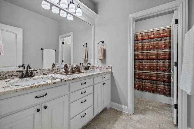 6401 S 47th St, Rogers, AR 72758 - bathroom with double vanity and baseboards