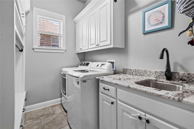 6401 S 47th St, Rogers, AR 72758 - laundry area featuring washing machine and clothes dryer, cabinet space, and baseboards