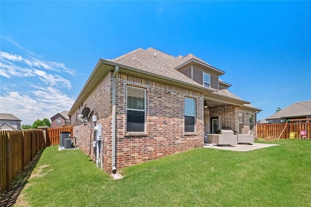 6401 S 47th St, Rogers, AR 72758 - back of house with brick siding, a patio area, central AC unit, outdoor lounge area, and roof with shingles