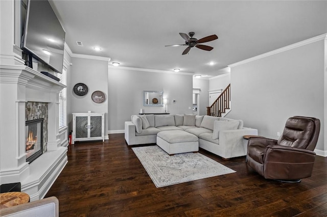 6401 S 47th St, Rogers, AR 72758 - living room featuring a ceiling fan, wood-type flooring, a tile fireplace, ornamental molding, and stairs