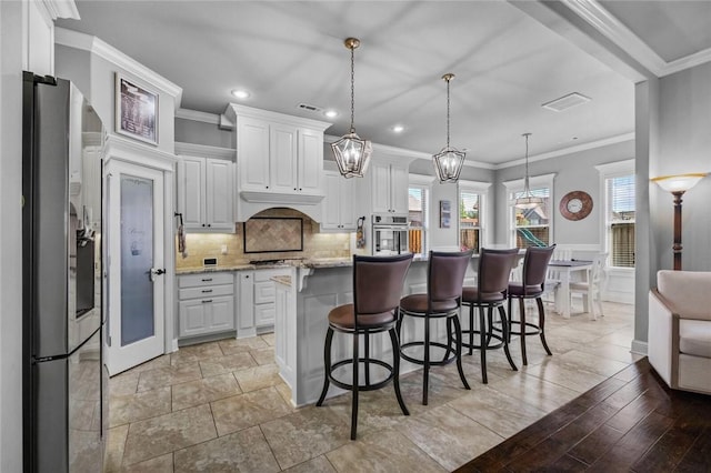 6401 S 47th St, Rogers, AR 72758 - kitchen featuring appliances with stainless steel finishes, white cabinetry, crown molding, a breakfast bar, and recessed lighting