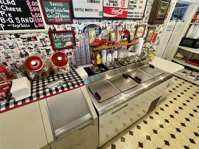 273 N Main St, Eureka Springs, AR 72632 - detailed view of tile patterned floors and black microwave